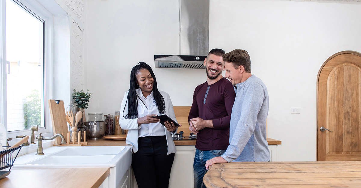 A same sex couple shopping for a home with their agent